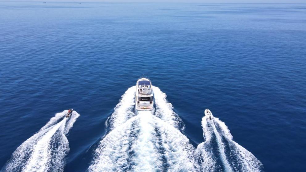 Motor yacht Dolphin at sea. On the sides you can see a jet ski and a tender
